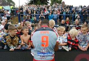 Picture by Ed Sykes/SWpix.com - 06/08/2023 - Rugby League - Betfred Super League Round 21 - Leeds Rhinos v Leigh Leopards - Headingley Stadium, Leeds, England - Leigh Leopards' Edwin Ipape signs autographs for fans after the game
